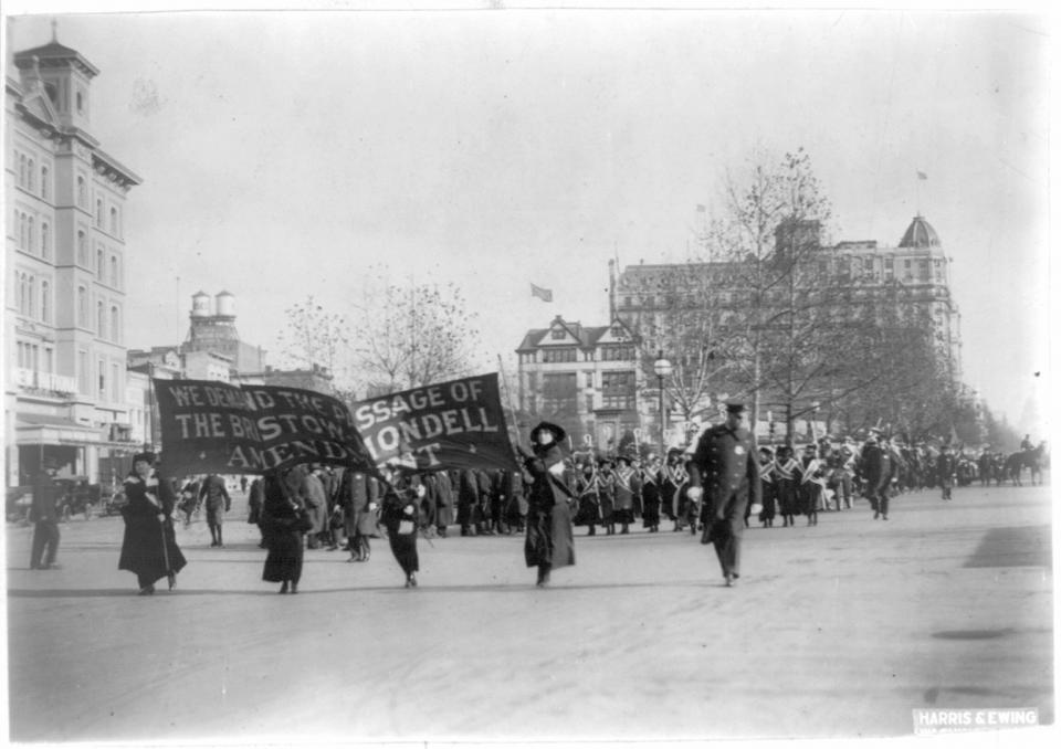 In this photo provided by the Library of Congress, taken in 1913, four women march ahead of large procession with the banner "We demand the passage of the Bristow-Mondell amendment" at the woman suffrage parade in Washington. Thousands of women take to the streets of Washington, demanding a greater voice for women in American political life as a new president takes power. This will happen on Saturday, Jan. 21, 2017, one day after the inauguration of Donald Trump. This DID happen more than 100 years ago, one day before the inauguration of Woodrow Wilson. (Library of Congress via AP)