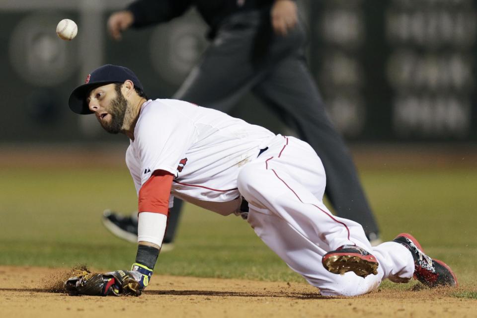 Boston Red Sox second baseman Dustin Pedroia knocks down the ball on a ground out by Texas Ranger J.P. Arencibia during the fifth inning of the MLB American League baseball game at Fenway Park, Monday, April 7, 2014, in Boston.(AP Photo/Charles Krupa)