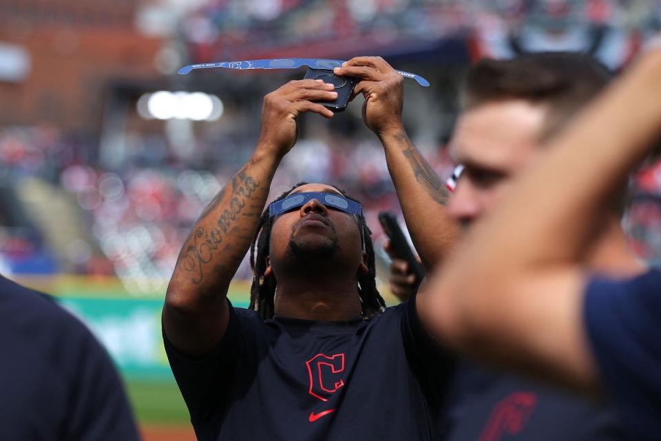 José Ramírez of the Cleveland Guardians looks up at the solar eclipse before the home opener against the Chicago White Sox, in Cleveland, Ohio.<span class="copyright">Mike Lawrie—Getty Images</span>