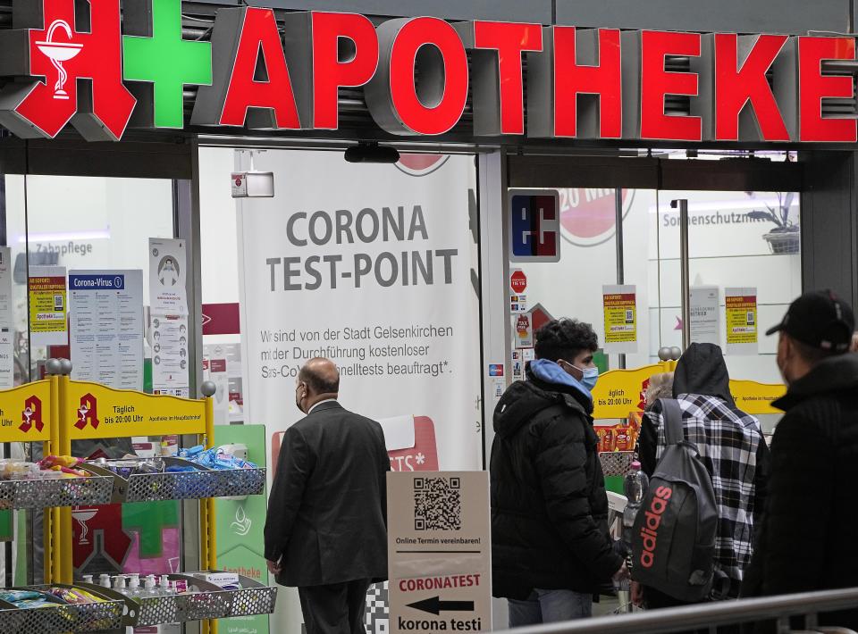 A man walks into a pharmacy, that offers corona tests in Gelsenkirchen, Germany, Friday, Nov. 12, 2021. Germany plans to bring back free Covid-19 rapid tests. (AP Photo/Martin Meissner)