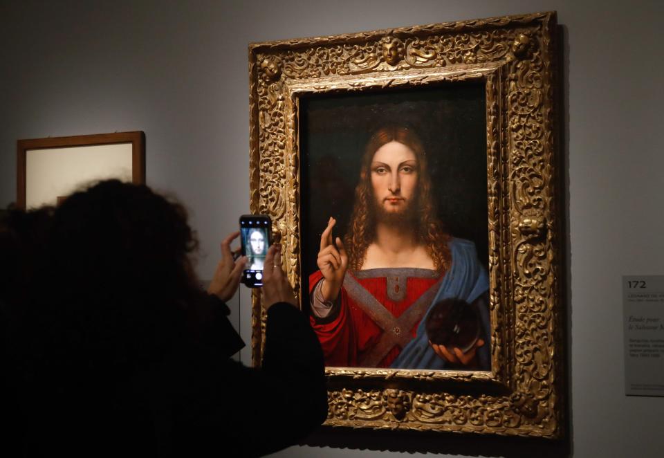 A version of "Salvator Mundi," attributed to Leonardo Da Vinci's workshop, is included in the Louvre's new exhibit on the Renaissance master. Another more controversial version, attributed to Leonardo himself, sold to an unnamed buyer at a 2017 auction for a record $450 million, but it is absent from the exhibit.