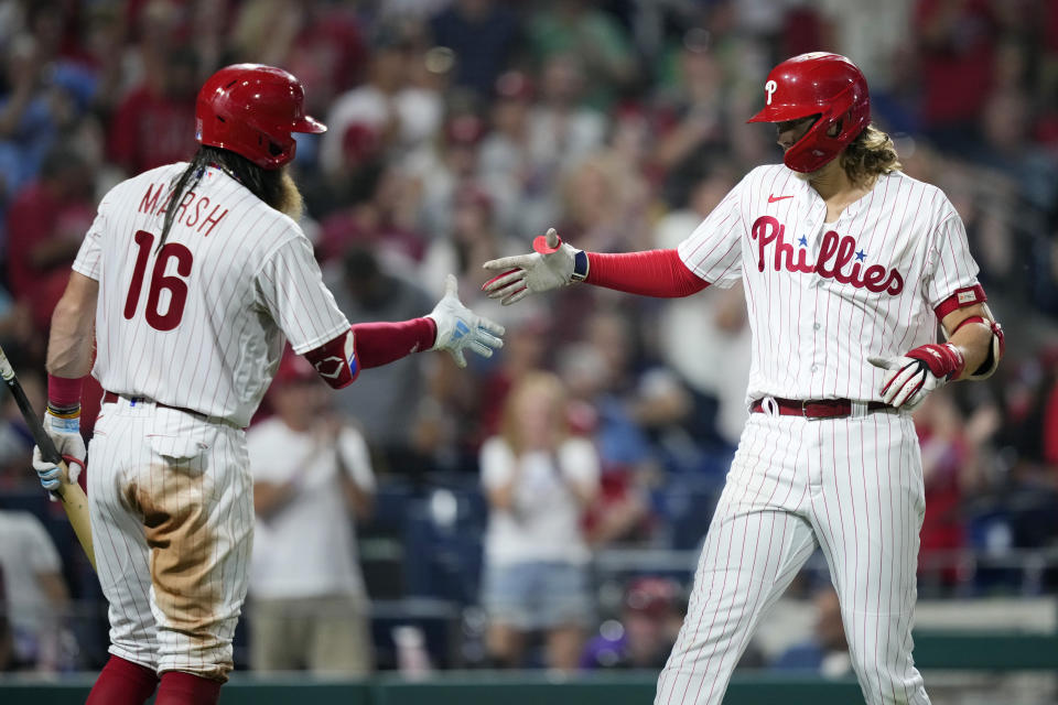 Philadelphia Phillies' Alec Bohm, right, and Brandon Marsh celebrate after Bohm's home run during the sixth inning of a baseball game against the St. Louis Cardinals, Friday, Aug. 25, 2023, in Philadelphia. (AP Photo/Matt Slocum)