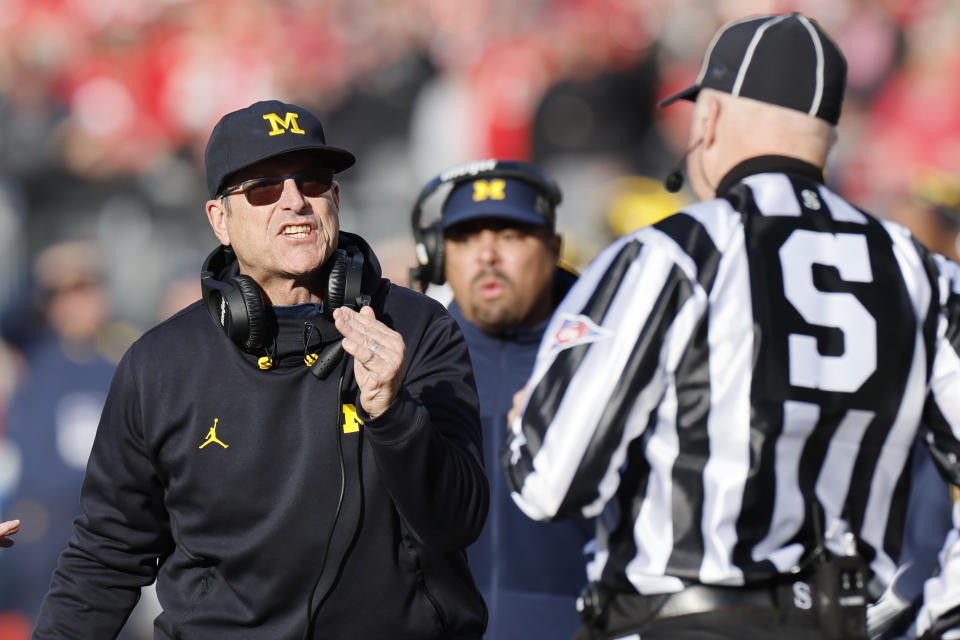 Michigan head coach Jim Harbaugh argues with a game official during the second half of an NCAA college football game against Ohio State on Saturday, Nov. 26, 2022, in Columbus, Ohio. (AP Photo/Jay LaPrete)