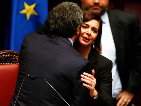 The new Chamber of Deputies president, Five Stars Movement (M5S) Roberto Fico kisses former president Laura Boldrini at the Chamber of Deputies during the second session day since the March 4 national election in Rome, Italy March 24, 2018. REUTERS/Tony Gentile