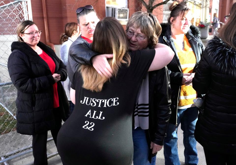 Members of the extended Rhoden family embrace after a jury convicted George Wagner IV of 22 different counts in the 2016 shooting deaths of seven Rhodens and one future member of the family.