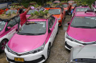 Workers from two taxi cooperatives assemble miniature gardens on the rooftops of unused taxis parked in Bangkok, Thailand, Thursday, Sept. 16, 2021. Taxi fleets in Thailand are giving new meaning to the term “rooftop garden,” as they utilize the roofs of cabs idled by the coronavirus crisis to serve as small vegetable plots and raise awareness about the plight of out of work drivers. (AP Photo/Sakchai Lalit)