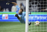 LA Galaxy goalkeeper John McCarthy allows a goal to Vancouver Whitecaps' Brian White during the second half of an MLS soccer match Saturday, April 13, 2024, in Vancouver, British Columbia. (Darryl Dyck/The Canadian Press via AP)