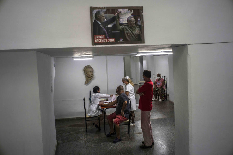 Nurses attend people who will be given a shot of the Cuban Abdala vaccine for COVID-19 at a cultural center being used as a vaccination center during the new coronavirus pandemic in Havana, Cuba, Monday, Aug. 2, 2021. (AP Photo/Ramon Espinosa)