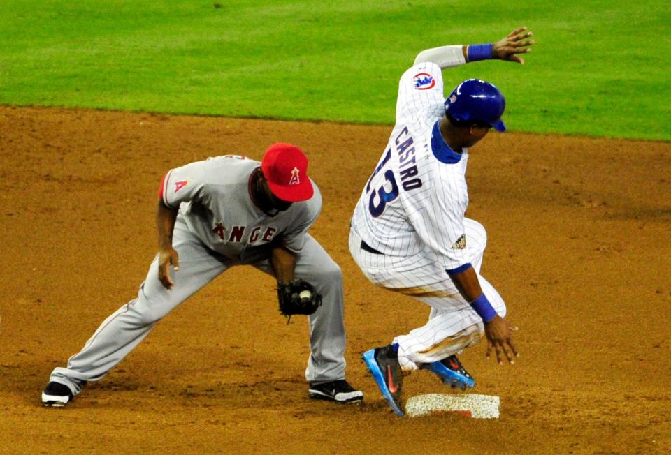 American League infielder Howie Kendrick (left) of the Angels tries to tag National League baserunner Starlin Castro on a stolen base during the 2011 All-Star Game.
