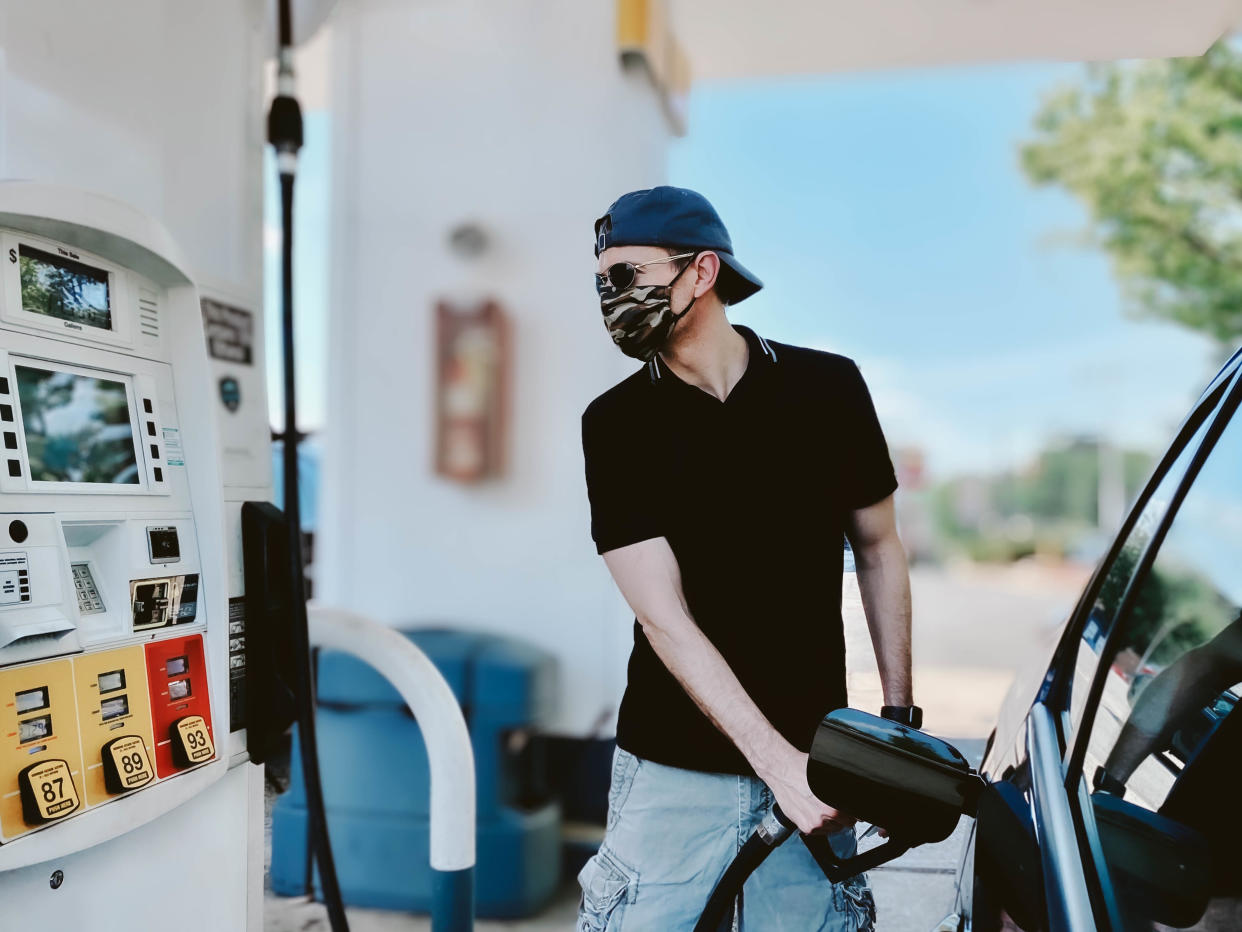 A man putting petrol in his car