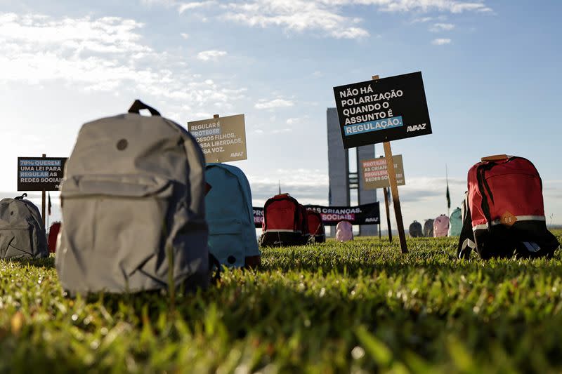 Members of Avaaz, a global web movement, protest in front of National Congress using backpacks to represent victims of school massacres lost due to lack of laws in the virtual world, in Brasilia