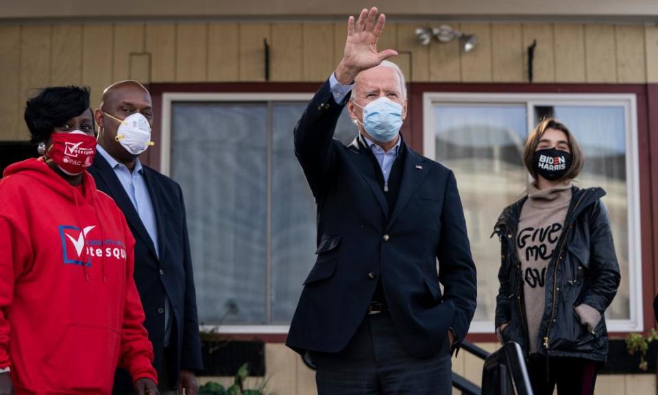 Democratic presidential nominee Joe Biden waves to supporters as he makes a stop with local elected officials at Relish Restaurant on November 03, 2020.