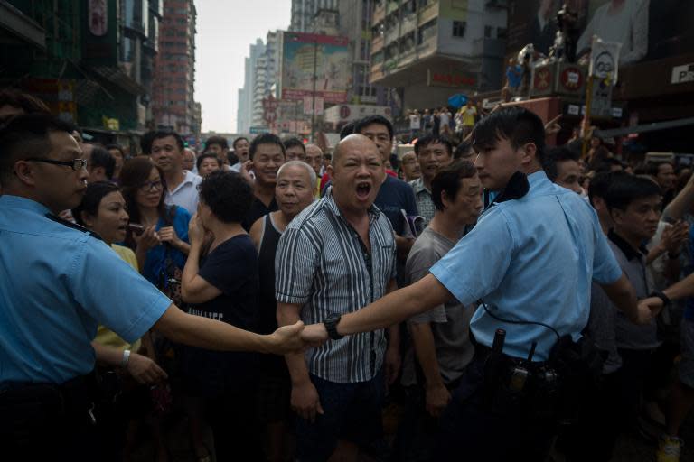 A government loyalist shouts at pro-democracy protesters in Mongkok district, Hong Kong, on October 3, 2014