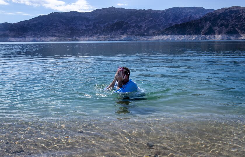 LAS VEGAS, NV -JULY 12, 2022: Chad Taylor, 44, cools off at a remote beach near the middle of the drought stricken Lake Mead on July 12, 2022 in Las Vegas, Nevada. The water levels at Lake Mead are at historic lows forcing the closures of all but one marina at the lake.(Gina Ferazzi / Los Angeles Times)