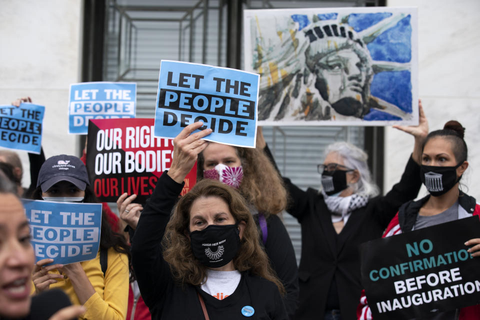 Protesters opposed to the confirmation of President Donald Trump's Supreme Court nominee Amy Coney Barrett, rally on Capitol Hill, in Washington, Tuesday, Oct. 13, 2020. (AP Photo/Jose Luis Magana)