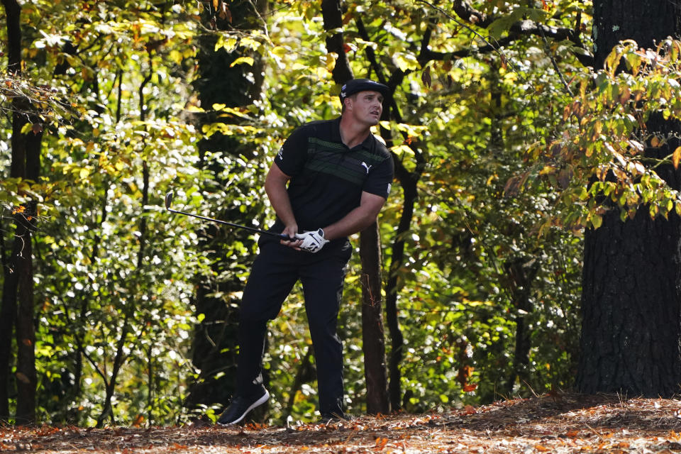 Bryson DeChambeau watches his shot out of the rough on the 11th hole during the first round of the Masters golf tournament Thursday, Nov. 12, 2020, in Augusta, Ga. (AP Photo/Chris Carlson)