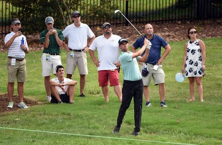 Aug 18, 2017; Greensboro, NC, USA; Webb Simpson hits out of the rough on the ninth hole during the second round of the Wyndham Championship golf tournament at Sedgefield Country Club. Mandatory Credit: Rob Kinnan-USA TODAY Sports