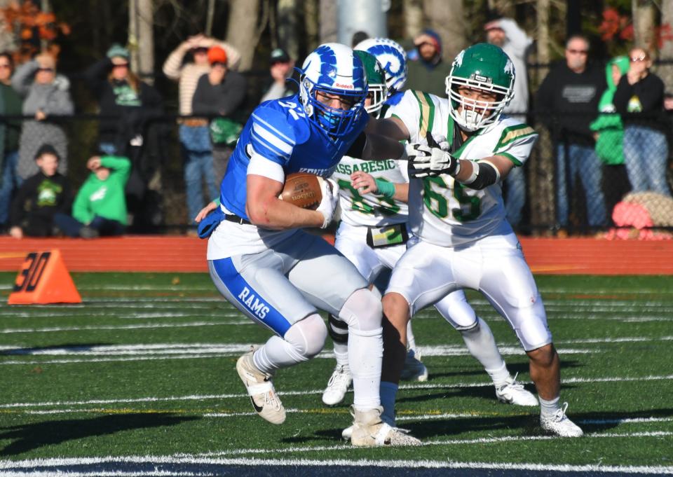 Kennebunk fullback Jonah Barstow, left, spins away from Massabesic’s Kobe Cairns on Saturday.