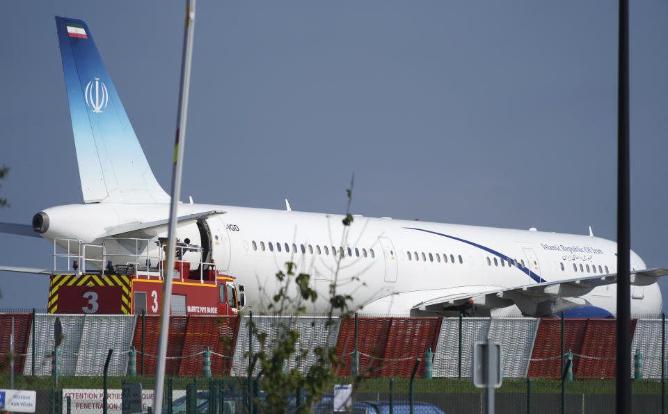 Aan Iranian plane can be seen at the airport in Biarritz, France Sunday, Aug. 25, 2019. Iranian Foreign Minister Mohammad Javad paid an unannounced visit Sunday to the G-7 summit and headed straight to the building where leaders of the world's major democracies have been debating how to handle the country's nuclear ambitions. The surprise arrival of Zarif came just two days after his meeting with France's president, who is the host of the Group of Seven gathering in Biarritz. (AP Photo/Mstyslav Chernov)