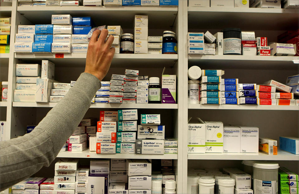 File photo dated 16/11/09 of a pharmacist stocking shelves at a chemist. Brexit has contributed to a shortage of some medicines at pharmacies in England as the number of in-demand drugs subsidised by the Government reached a record high, it is claimed.