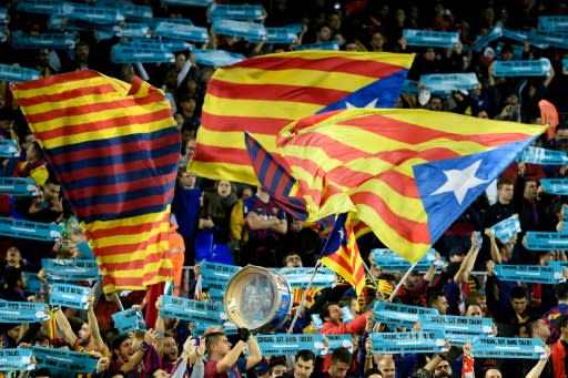 Barcelona supporters wave Catalan pro-independence "Estelada" flags before the Clasico