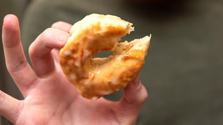 Hand holding air fryer biscuit donut 