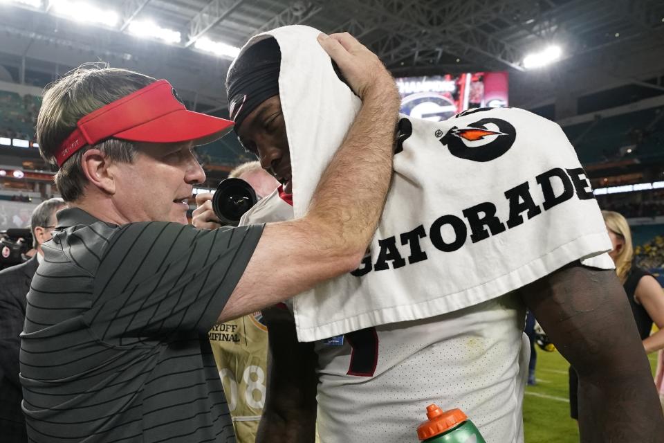 Georgia head coach Kirby Smart greets wide receiver Jermaine Burton after their win against Michigan in the Orange Bowl NCAA College Football Playoff semifinal game, Friday, Dec. 31, 2021, in Miami Gardens, Fla. Georgia won 34-11. (AP Photo/Lynne Sladky)