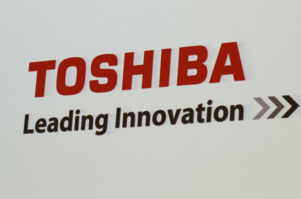 FILE - In this June 15, 2017, file photo, the logo of Toshiba Corp., Japan's electronics and energy company, is seen on a screen during a press conference in Yokosuka, near Tokyo. Trading in Toshiba stock was halted Wednesday, April 7, 2021 after the Tokyo-based technology conglomerate confirmed it had received a preliminary acquisition proposal. Toshiba Corp. said Tuesday, April 6 it had asked for more details on the proposal, was giving it “careful consideration” and would make an announcement “in due course.” (AP Photo/Shuji Kajiyama)