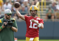 CORRECTS DATE Green Bay Packers' quarterback Aaron Rodgers passes during NFL football training camp Wednesday, July 28, 2021, in Green Bay, Wis. (AP Photo/Matt Ludtke)