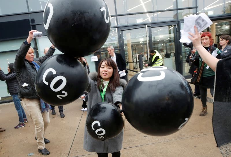 FILE PHOTO: Activists protest against the carbon dioxide emissions trading in front of the World Congress Centre Bonn, the site of the COP23 U.N. Climate Change Conference, in Bonn