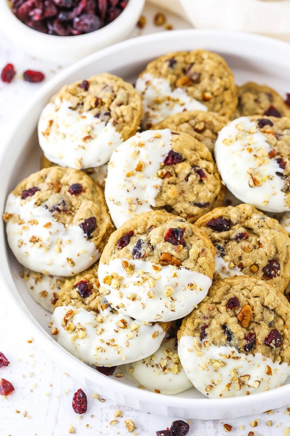 White chocolate-dipped cranberry oatmeal cookies from food blog Life, Love and Sugar.