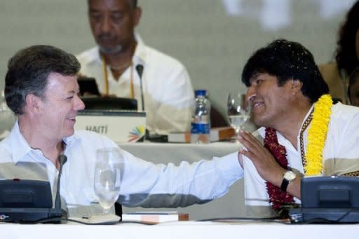 Bolivia's President Evo Morales and Colombia's President Juan Manuel Santos gesture during the closing ceremony of the Social Forum of Cartagena, ahead of Summit of the Americas