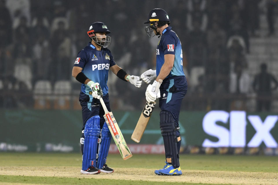 Multan Sultans' Mohammad Rizwan, left, celebrates with David Willey after hitting a boundary during the Pakistan Super League T20 cricket match between Multan Sultans and Lahore Qalandars in Multan, Pakistan Wednesday, Feb. 21, 2024. (AP Photo/M. Khan)