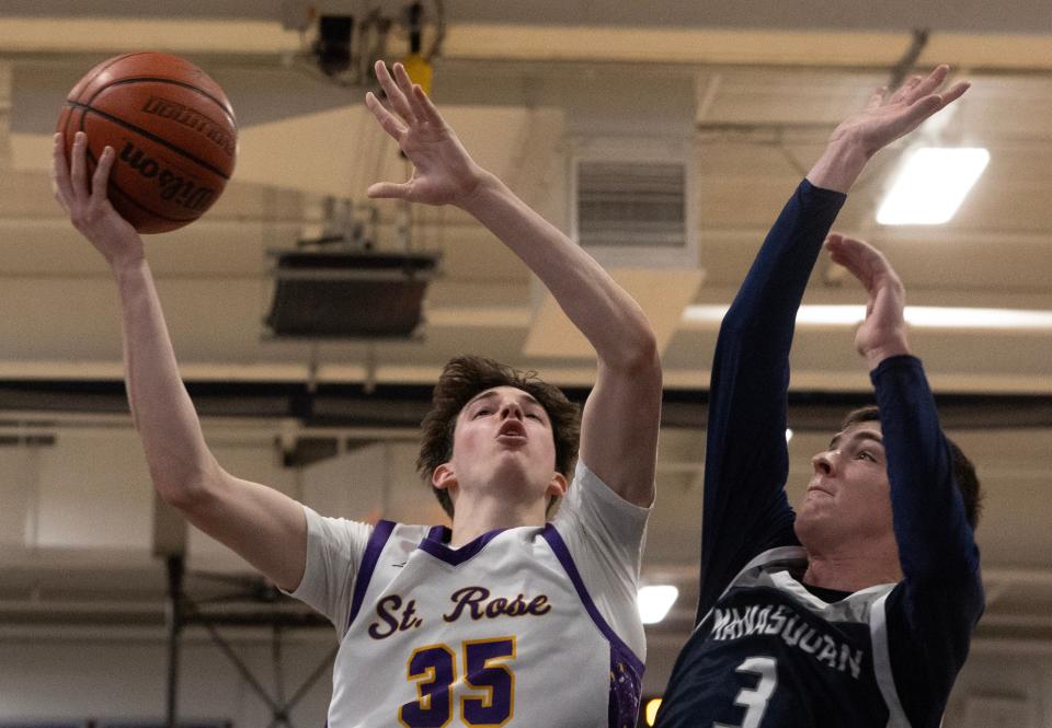 St. Rose Evan Romano goes up with shot as Manasquan Jason Larned shoots. St. Rose Boys Basketball dominates Manasquan in Manasquan, NJ on January 22, 2024.