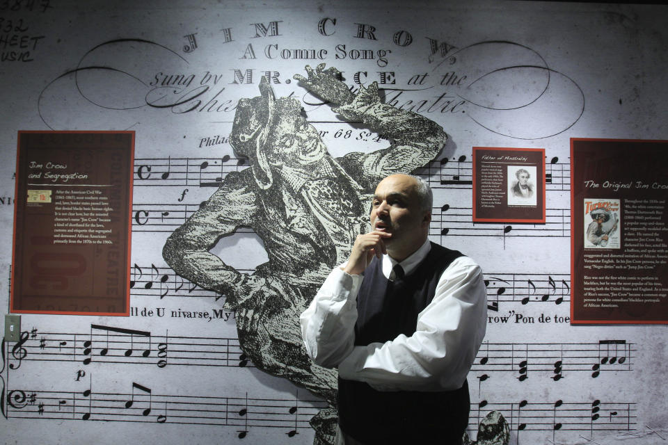 In a March 14, 2012 photo, David Pilgrim, the founder and curator who started building the Jim Crow Museum of Racist Memorabilia, stands in the museum's entrance in Big Rapids, Mich. The museum says it has amassed the nation’s largest public collection of artifacts spanning the segregation era, from Reconstruction until the civil rights movement, and beyond. (AP Photo/Carlos Osorio)