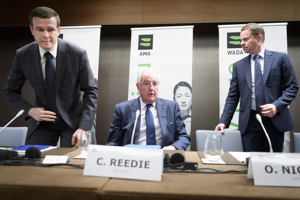 FILE - In this file photo dated Monday, Dec. 9, 2019, President-Elect of World Anti-Doping Agency (WADA) Witold Banka, left, President of World Anti-Doping Agency (WADA) Craig Reedie, center, and Director General of World Anti-Doping Agency (WADA) Olivier Niggli, right, arrive for a press conference after the WADA's extraordinary Executive Committee (ExCo) on the Russian doping data manipulation, in Lausanne, Switzerland. WADA announced a ban for Russia from international sporting events for four years. The Court of Arbitration for Sport judges will start on Monday Nov. 2, 2020, hearing four days of evidence and argument about allegations of a manipulated database from the Moscow testing laboratory. (Laurent Gillieron/Keystone FILE via AP)