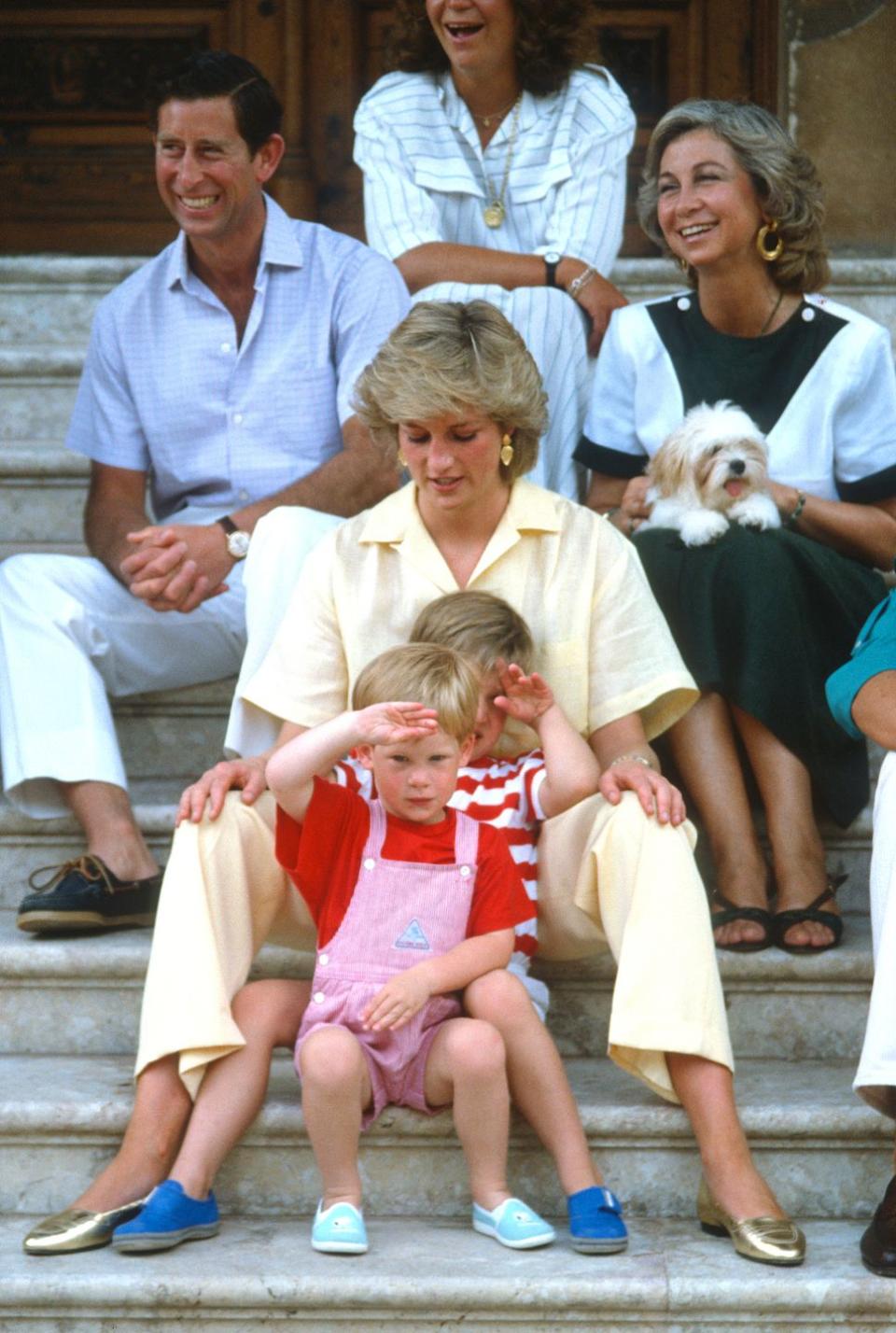 palma, majorca august 10 prince charles, prince of wales, diana, princess of wales, wearing a yellow jumpsuit, prince william and prince harry sit on the steps of marivent palace with queen sofia of spain and other members of the spanish royal family on august 10, 1987 in palma, majorca photo by anwar husseingetty images