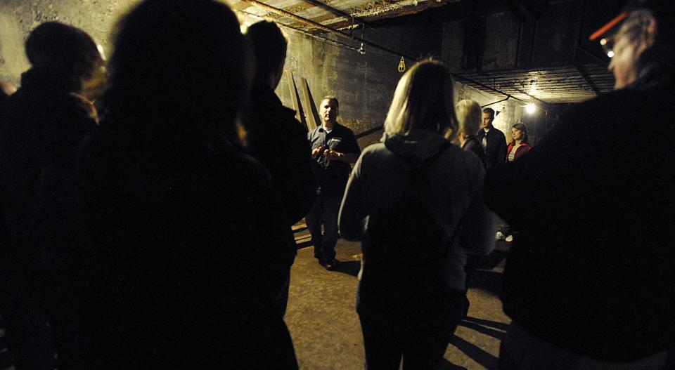 Chris Sirianni, center, facing camera, owner of The Brewerie at Union Station, leads a ghost tour in the basement of the building in 2012.