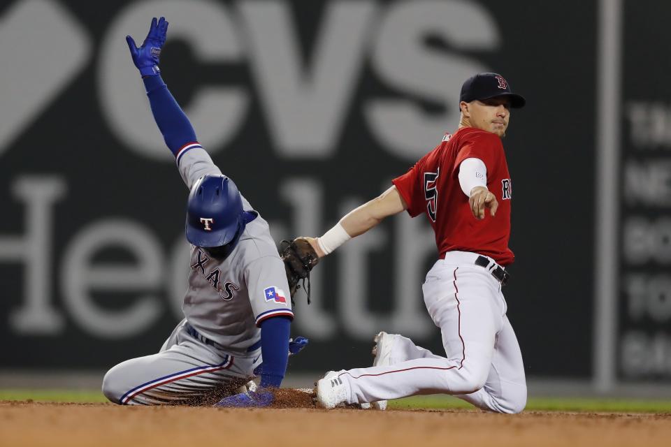 Texas Rangers' Adolis Garcia, left, is safe at second base with a double after a late tag by Boston Red Sox's Enrique Hernandez (5) during the third inning of a baseball game, Saturday, Aug. 21, 2021, in Boston. (AP Photo/Michael Dwyer)