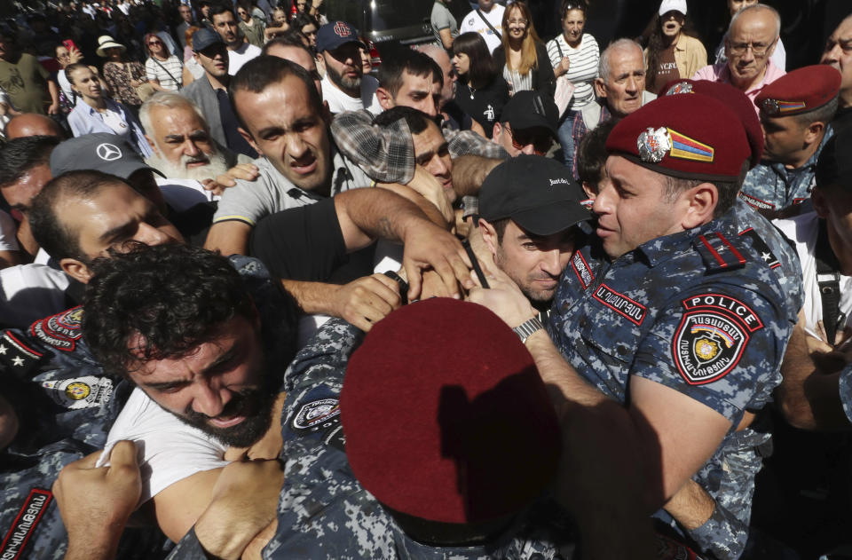 Police officers try to detain demonstrators during a protest against Prime Minister Nikol Pashinyan in Yerevan, Armenia, Friday, Sept. 22, 2023. (Vahram Baghdasaryan/Photolure via AP)