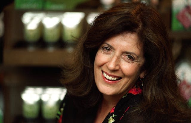 Body Shop founder Anita Roddick poses in her High Street Kensington store in 2001