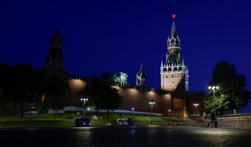 Law enforcement vehicles are seen in front of the Kremlin's Spasskaya Tower in central Moscow