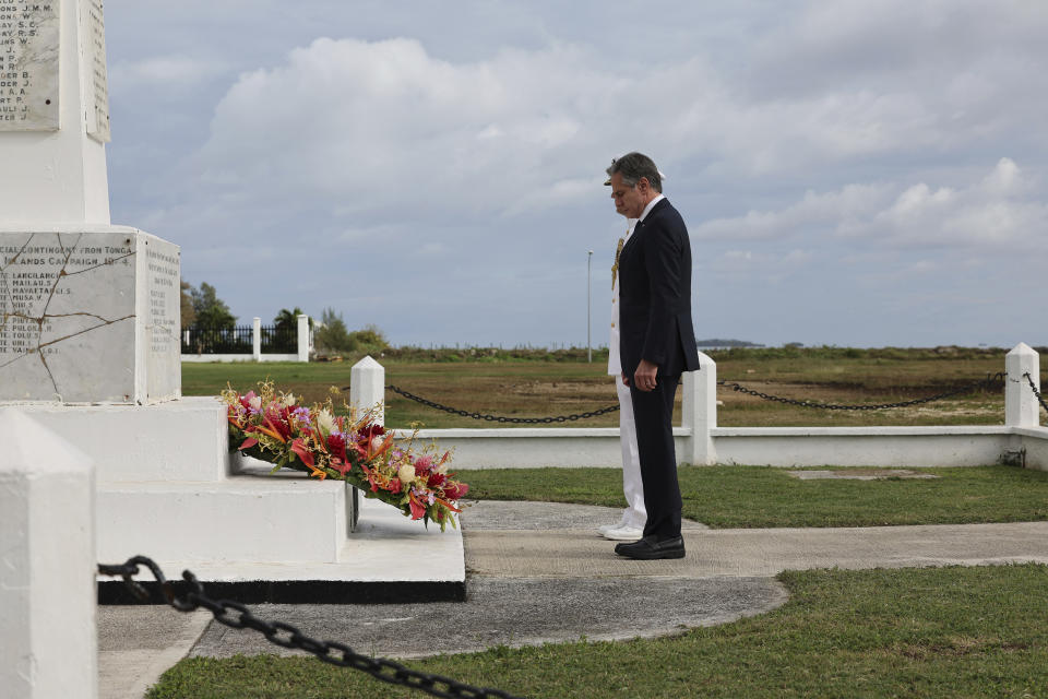 U.S. Secretary of State Antony Blinken, foreground, attends a wreath-laying ceremony at Tonga's War Memorial in Nuku'alofa, Tonga Wednesday, July 26, 2023. (Tupou Vaipulu/Pool Photo via AP)