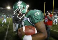 Saskatchewan Roughriders quarterback Darian Durant walks off the field with the game ball after his team defeated the Hamilton Tiger-Cats in the CFL's 101st Grey Cup championship football game in Regina, Saskatchewan November 24, 2013. REUTERS/Todd Korol (CANADA - Tags: SPORT FOOTBALL)