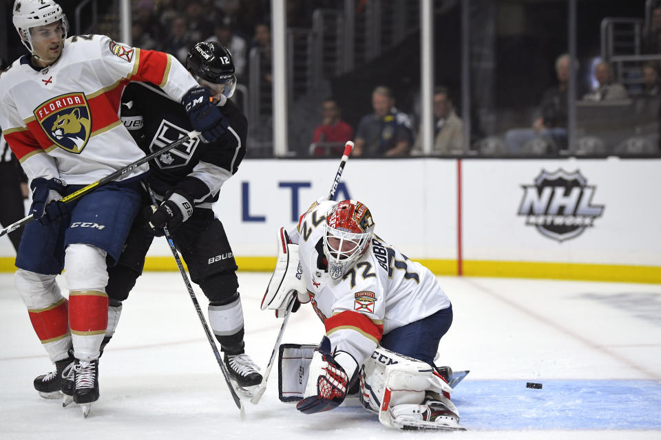 Florida Panthers goaltender Sergei Bobrovsky, right, is scored on by Los Angeles Kings center Trevor Moore, center, as defenseman Josh Brown defends during the second period of an NHL hockey game Thursday, Feb. 20, 2020, in Los Angeles. (AP Photo/Mark J. Terrill)