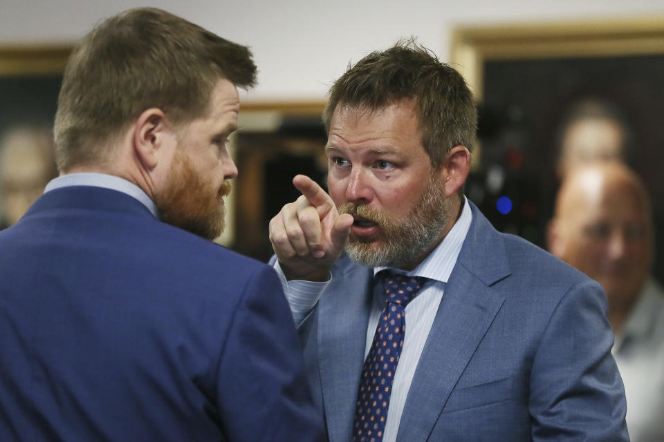 Wesley Ball speaks to Mark Bankston, lawyers representing Neil Heslin and Scarlett Lewis, parents of Sandy Hook shooting victim Jesse Lewis, during trial at the Travis County Courthouse in Austin, Wednesday Aug. 3, 2022. Jones testified Wednesday that he now understands it was irresponsible of him to declare the Sandy Hook Elementary School massacre a hoax and that he now believes it was “100% real." (Briana Sanchez/Austin American-Statesman via AP, Pool)