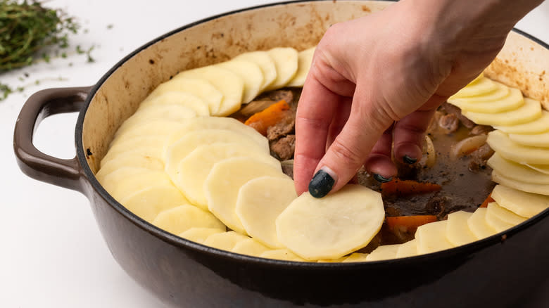 Adding potatoes to Lancashire hotpot