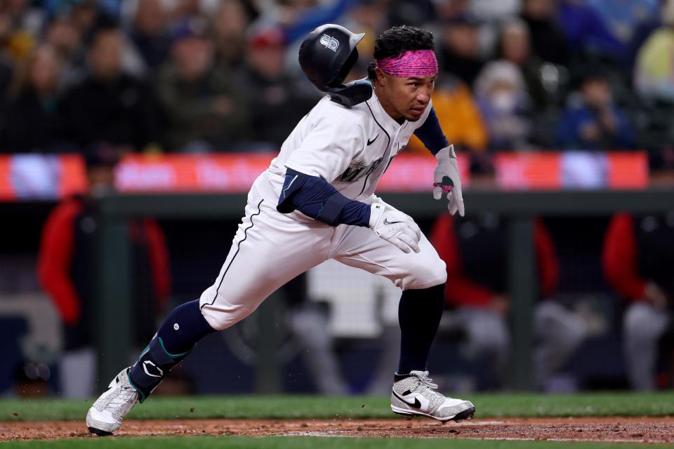 Kolten Wong of the Seattle Mariners runs to first base during the fourth inning against the Cleveland Guardians during Opening Day at T-Mobile Park on March 30, 2023 in Seattle, Washington.