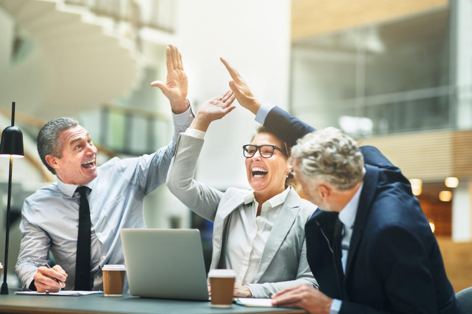 Business people giving high five