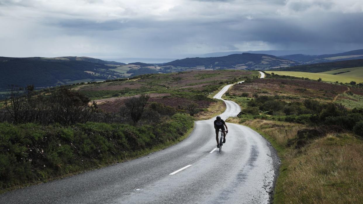 lone cyclist on winding road